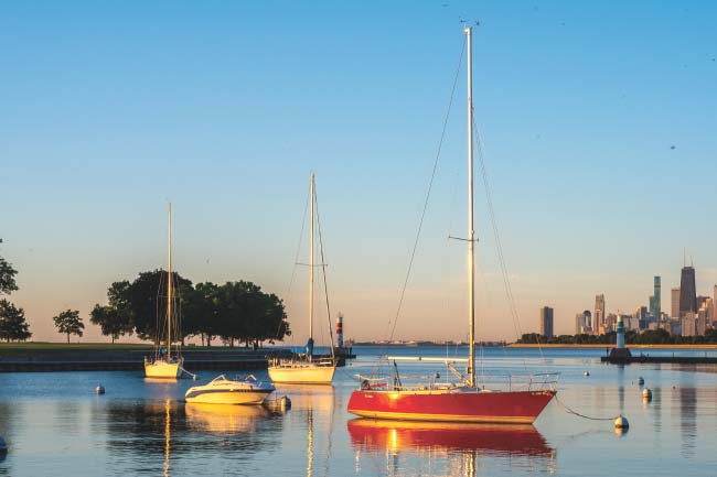 sail boats in a harbor with part of the Chicago skyline in the background